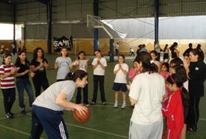 Rita Kevorkian teaches basketball moves to children.